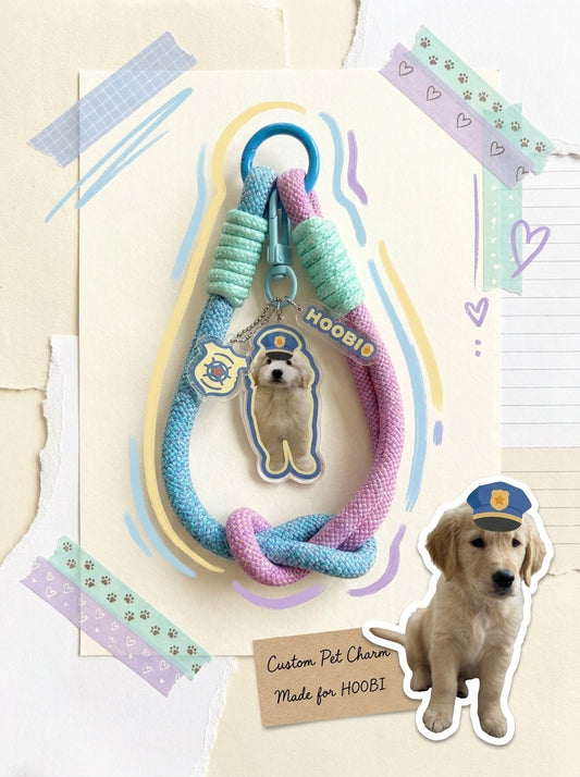 Custom pet phone charm with personalized dog photo on a blue and pink wrist strap